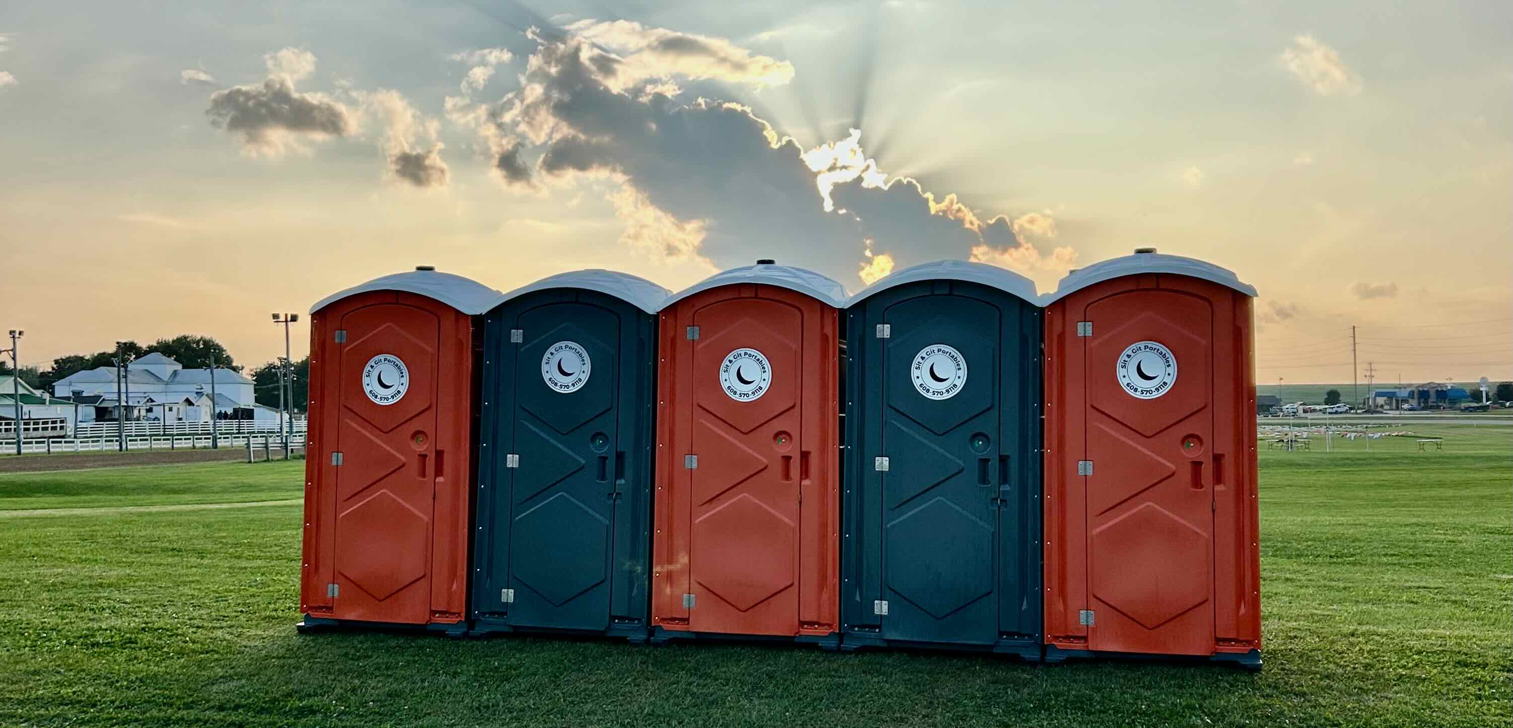 Portable restroom (portable toilet/porta potty) unit at a tidy outdoor site