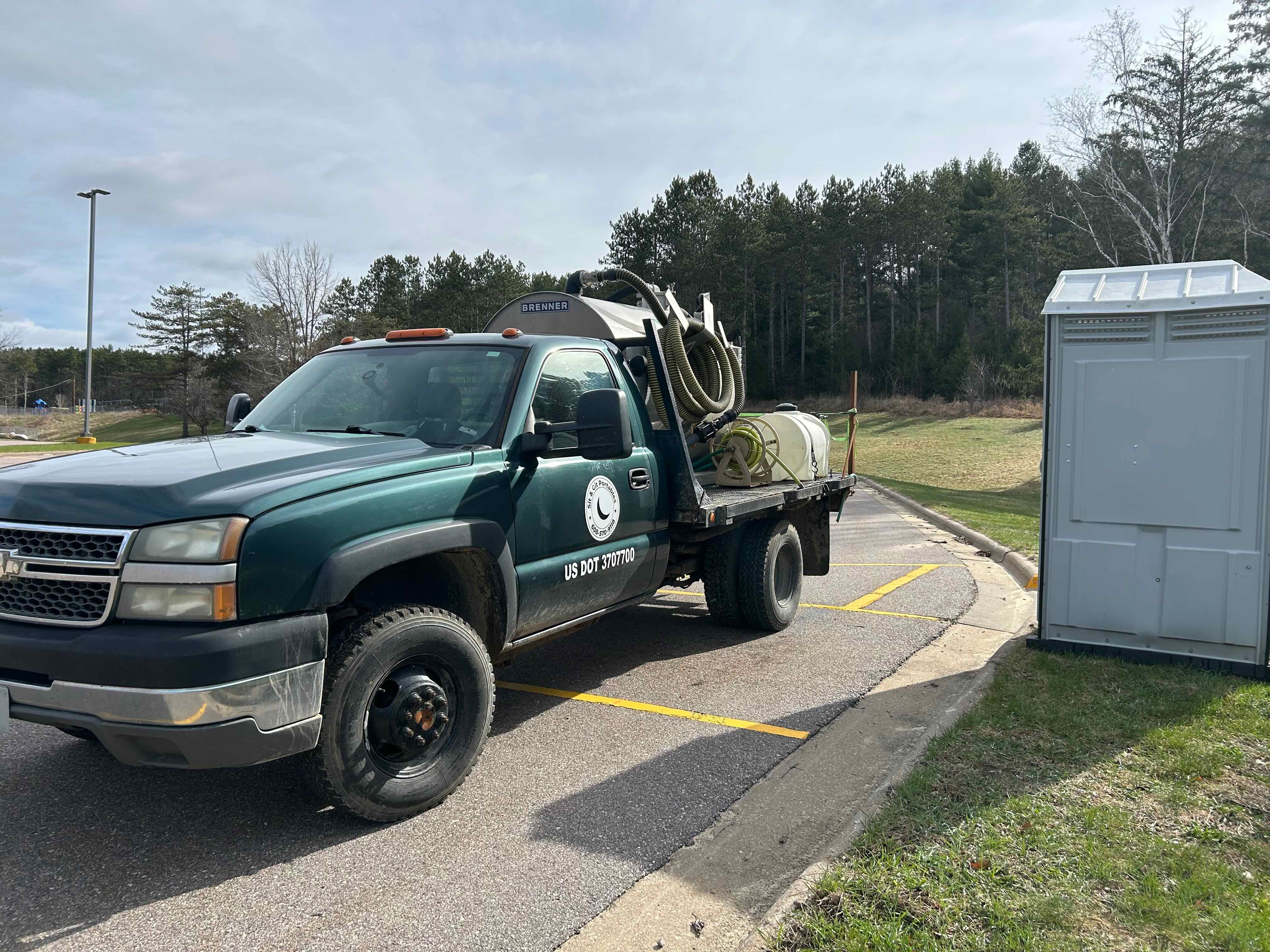 Service truck and portable restroom (portable toilet/porta potty)